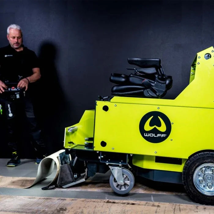 Wolff Independence Battery Ride-On Floor Stripper being operated on a wooden floor.